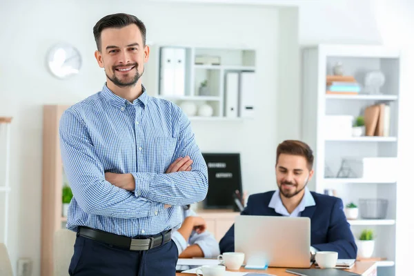 Young businessman with his partners in office — Stock Photo, Image