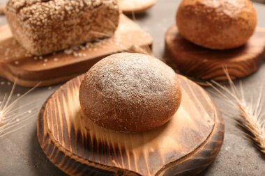 Gri zemin üzerinde taze ekmek olan tahta