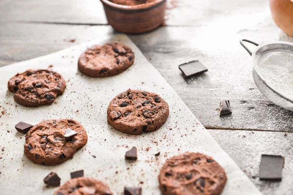 带有面粉、木制背景的美味巧克力饼干 — 图库照片