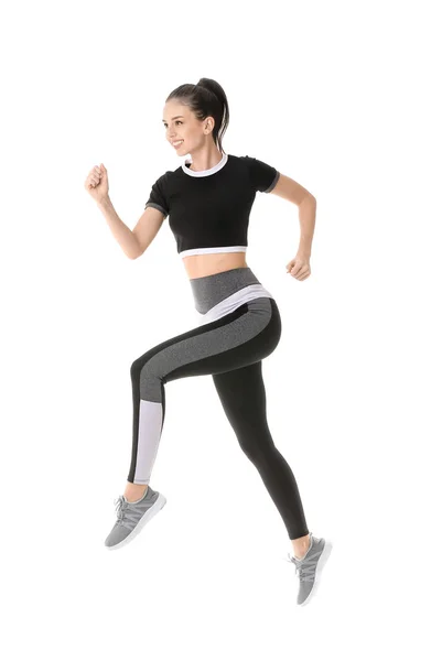 Sportief lopende jonge vrouw tegen witte achtergrond — Stockfoto