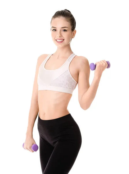 Sportovní mladá žena s činkami proti bílému pozadí — Stock fotografie