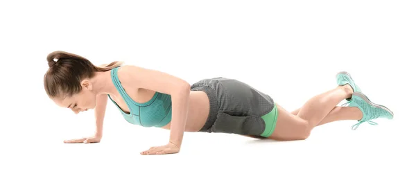 Sporty young woman training against white background — Stock Photo, Image