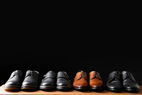 Stylish shoes on table against dark background — Stock Photo, Image