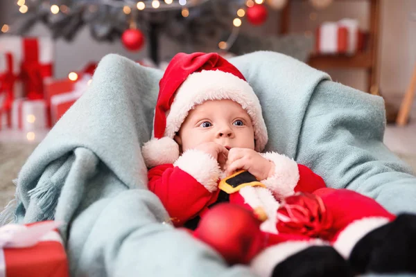 Cute little baby in Santa Claus costume at home — Stock Photo, Image