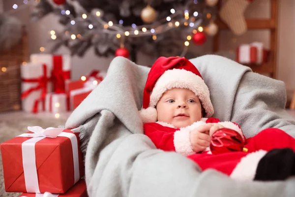 Cute little baby in Santa Claus costume at home — Stock Photo, Image