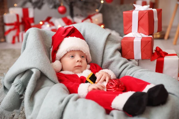 Bebê bonito em traje de Papai Noel em casa — Fotografia de Stock