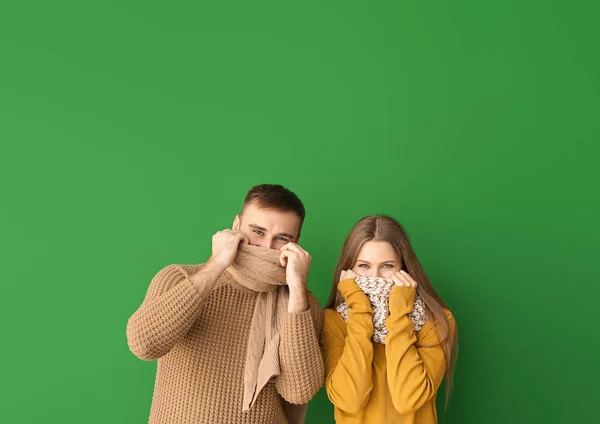 Retrato de pareja feliz en ropa de invierno sobre fondo de color — Foto de Stock