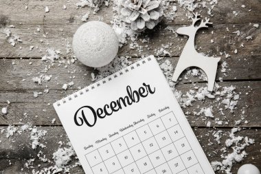 Ahşap arka planda Noel dekoru, kar ve takvim
