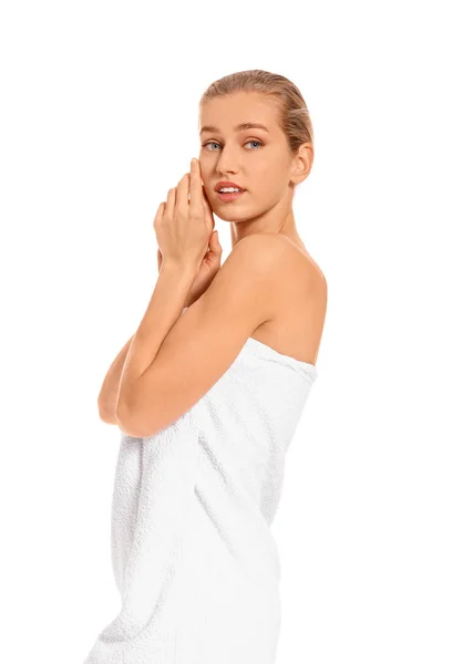 Beautiful young woman wrapped in towel on white background — Stock Photo, Image