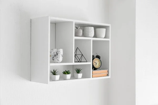 Shelf with decor hanging on white wall — Stock Photo, Image