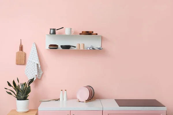 Interior of kitchen with modern shelf hanging on color wall — Stock Photo, Image