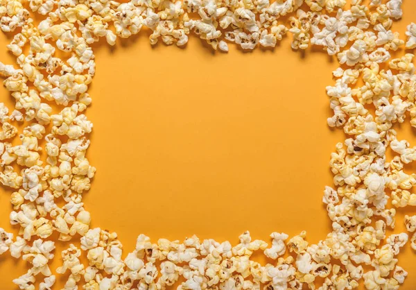 Frame made of tasty popcorn on color background — Stock Photo, Image