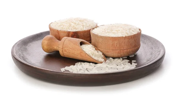 Tigelas e colher com arroz cru no fundo branco — Fotografia de Stock