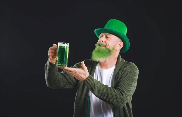 Funny mature man with glass of beer on dark background. St. Patrick's Day celebration — Stock Photo, Image