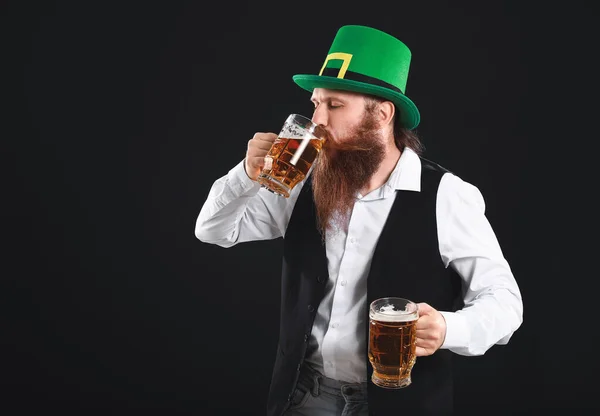 Bearded man with glasses of beer on dark background. St. Patrick's Day celebration — Stock Photo, Image