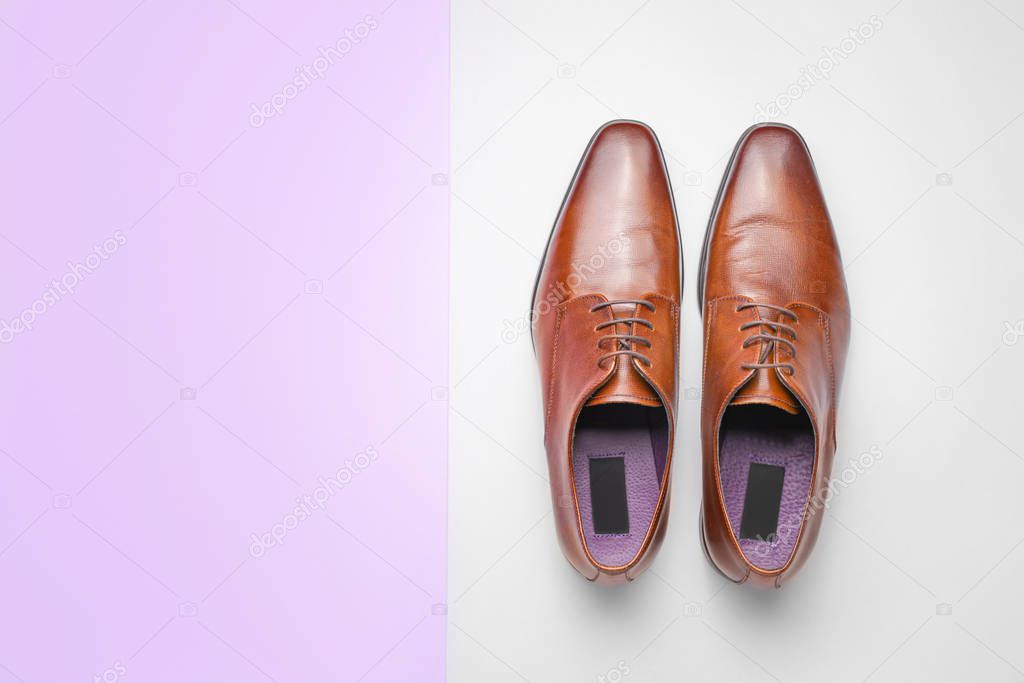 Stylish male shoes on color background