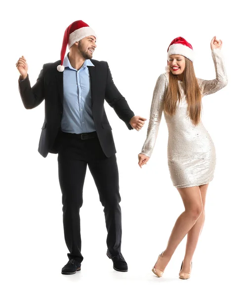 Happy couple in Santa Claus hats on white background — Stock Photo, Image