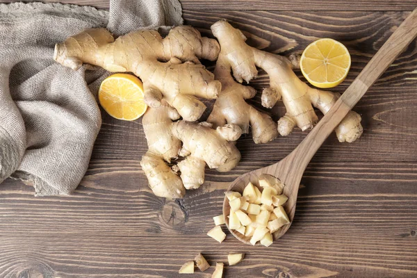 Fresh ginger with lemon on wooden table — Stock Photo, Image