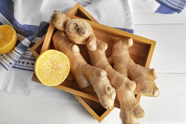 Fresh ginger with lemon on white table — Stock Photo, Image