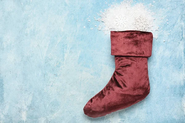Christmas sock with snow on color background — Stock Photo, Image