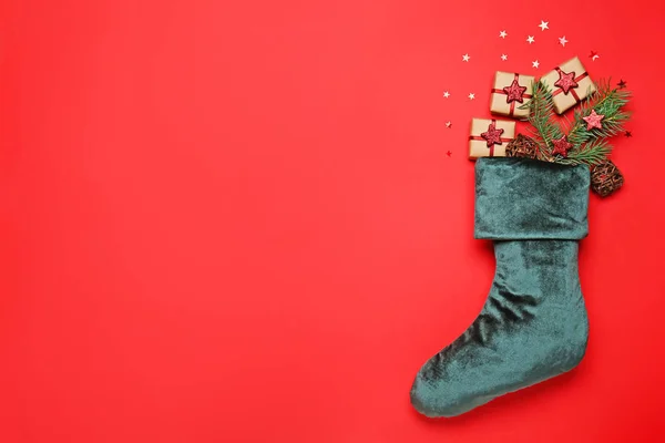 Christmas sock with gifts on color background — Stock Photo, Image