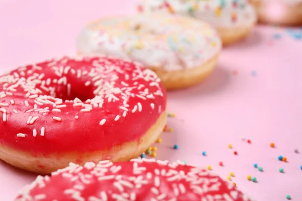 Sweet tasty donuts on color background — Stock Photo, Image