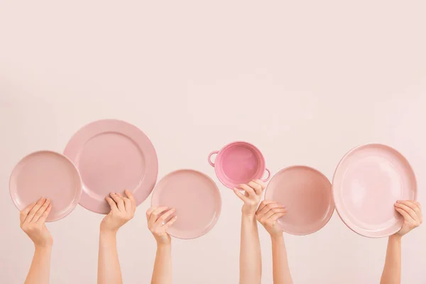 Hands with different clean plates on color background — Stock Photo, Image