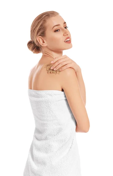 Mulher bonita aplicando esfoliação corporal contra fundo branco — Fotografia de Stock