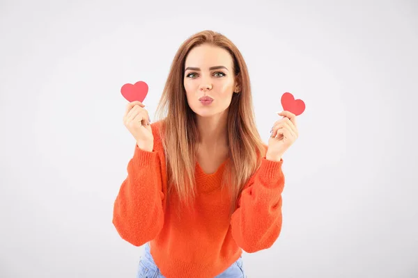 Beautiful young woman with small red hearts on white background — Stock Photo, Image