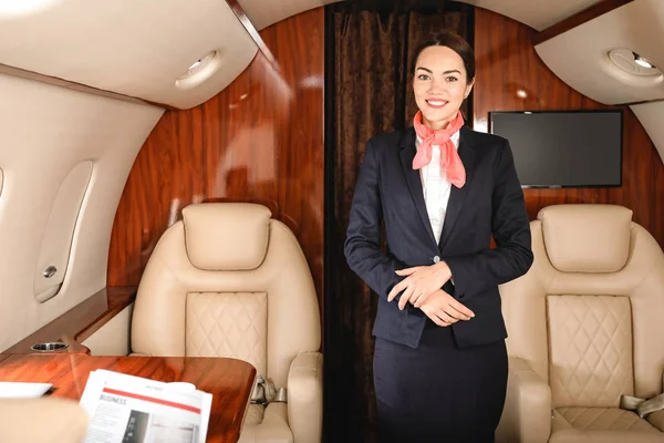 Air hostess on board the modern private airplane — Stock Photo, Image