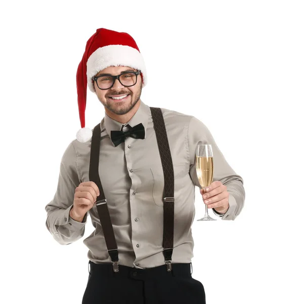 Beau jeune homme au chapeau de Père Noël et avec une coupe de champagne sur fond blanc — Photo