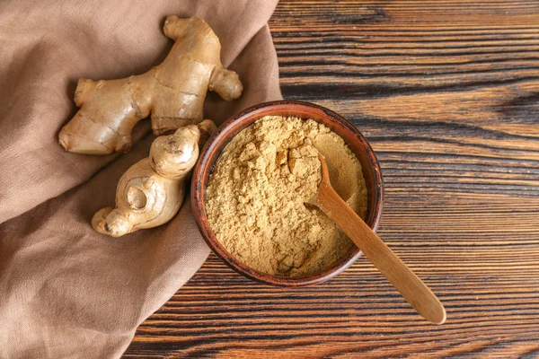 Bowl with ground ginger on wooden table — Stock Photo, Image