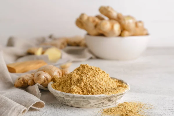 Plate with ground ginger on white table — Stock Photo, Image