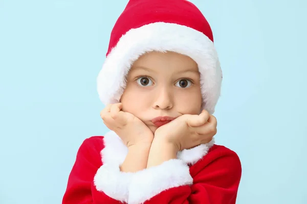 Cute little boy in Santa costume on color background — Stock Photo, Image