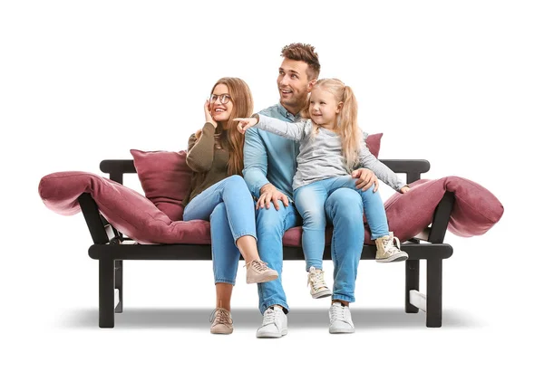 Happy young family sitting on sofa against white background — Stock Photo, Image
