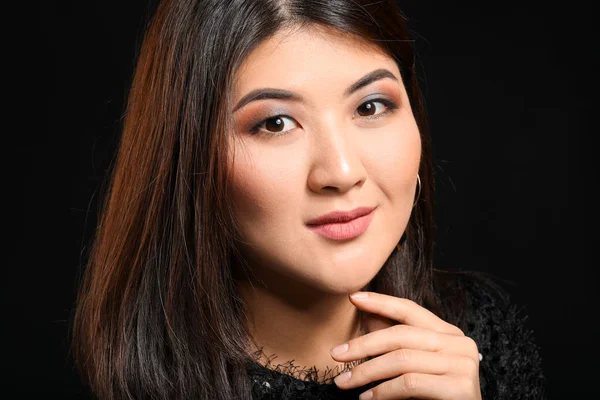 Portrait of young Asian woman on dark background — Stock Photo, Image