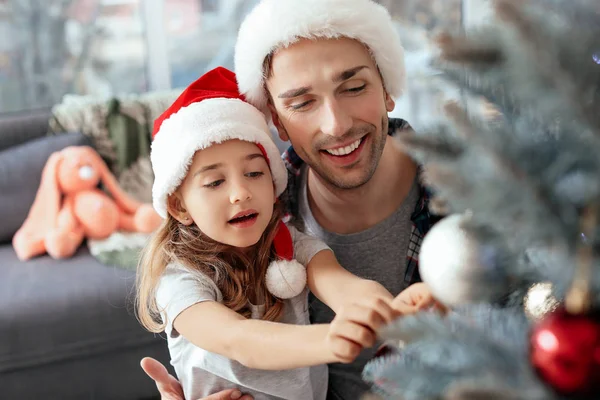 Little girl and her father decorating Christmas tree at home — Stock Photo, Image