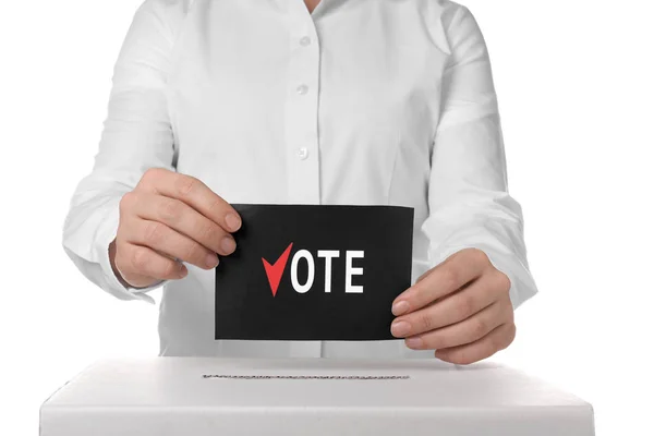 Woman putting ballot paper in voting box against white background — 스톡 사진