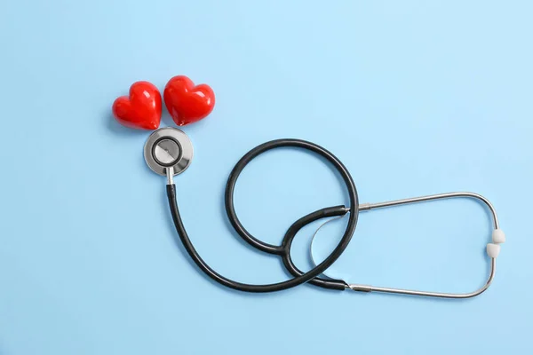 Stetoskop ve arka planda kırmızı kalpler. Kardiyoloji kavramı — Stok fotoğraf