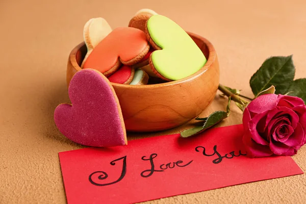 Bowl with tasty heart-shaped cookies and rose flower on color background. Valentines Day celebration — Stock Photo, Image