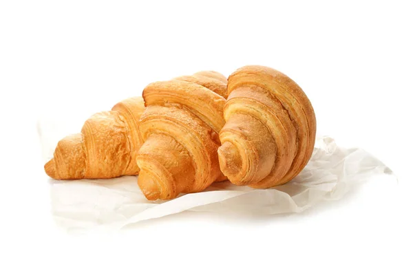 Parchment with tasty croissants on white background — Stock Photo, Image