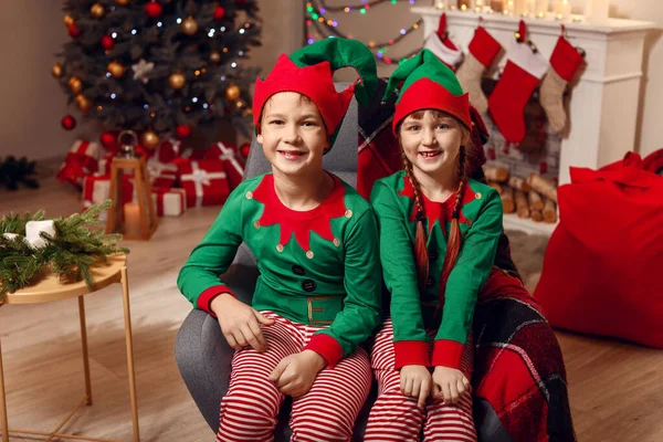 Little children in costume of elf in room decorated for Christmas — Stock Photo, Image