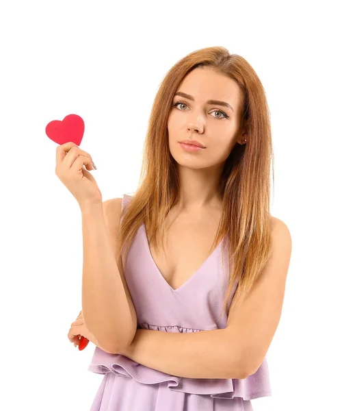 Beautiful young woman with small red heart on white background — Stock Photo, Image