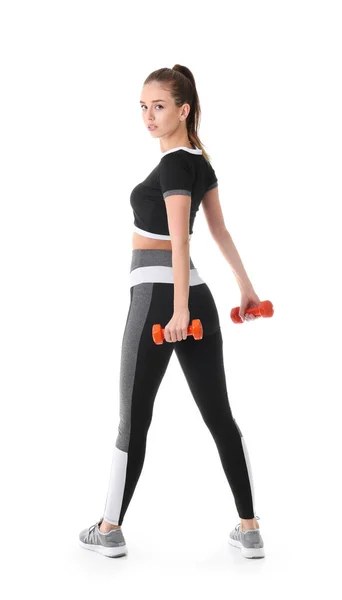 Sporty young woman with dumbbells against white background — Stock Photo, Image