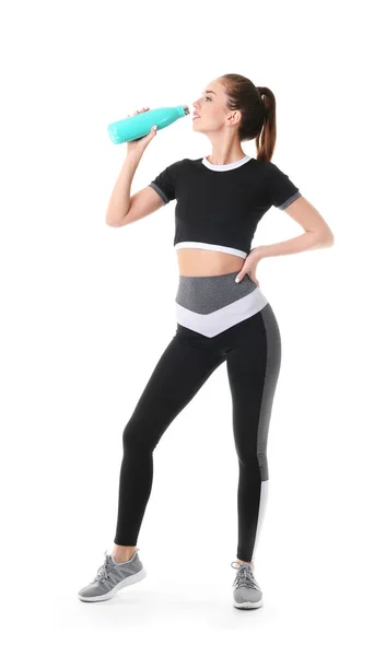 Sporty young woman with bottle of water on white background — Stock Photo, Image