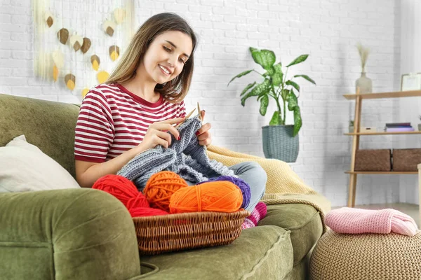 Young woman knitting warm sweater at home — Stock Photo, Image