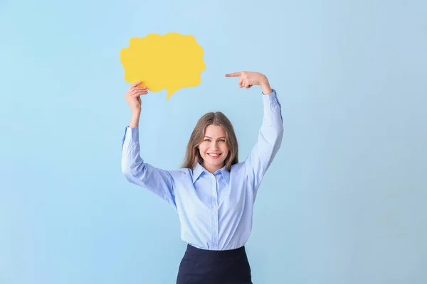 Young businesswoman with blank speech bubble on color background — Stock Photo, Image