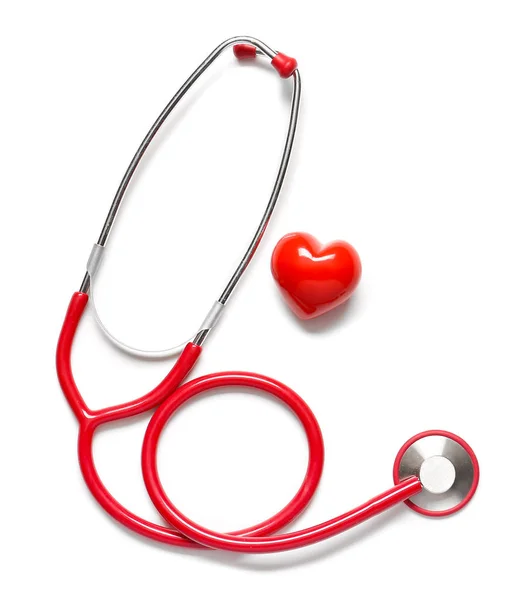 Stethoscope and red heart on white background. Cardiology concept — Stock Photo, Image