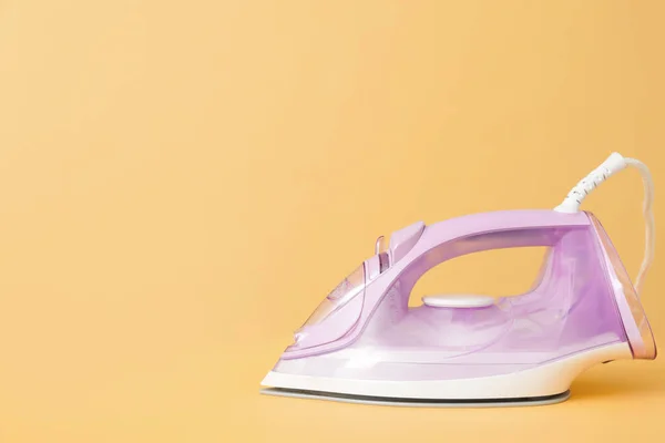 Electric iron on color background — Stock Photo, Image