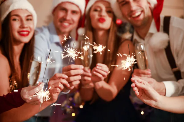 Amis avec des étincelles célébrant le Nouvel An à la fête — Photo